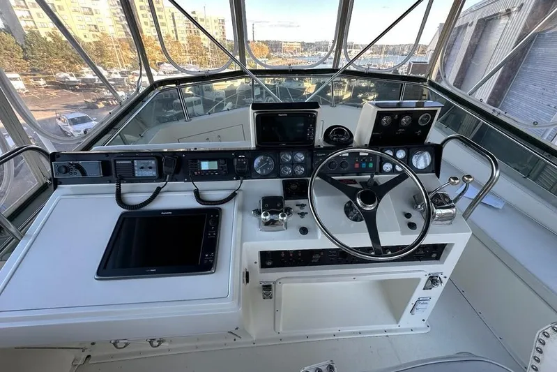 Summer Shack Yacht Photos Pics Helm of 1988 Hatteras 48 Convertible yacht with navigation instruments and steering wheel.