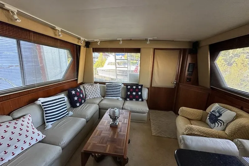 Summer Shack Yacht Photos Pics Interior of 1988 Hatteras 48 Convertible yacht with cozy seating and nautical decor.