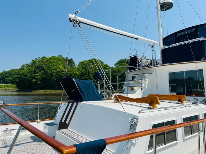 Sora Yacht Photos Pics 1998 Grand Banks 49 Classic yacht docked by a scenic riverside.