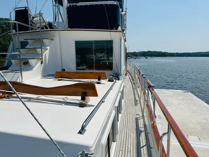 Sora Yacht Photos Pics 1998 Grand Banks 49 Classic yacht on calm water, showcasing deck and railing.