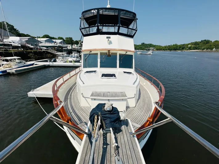 Sora Yacht Photos Pics 1998 Grand Banks 49 Classic yacht docked in a serene marina setting.