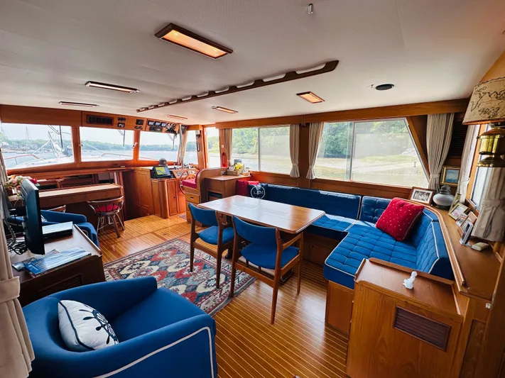Sora Yacht Photos Pics Interior of 1998 Grand Banks 49 Classic yacht with elegant wood finish and blue seating.