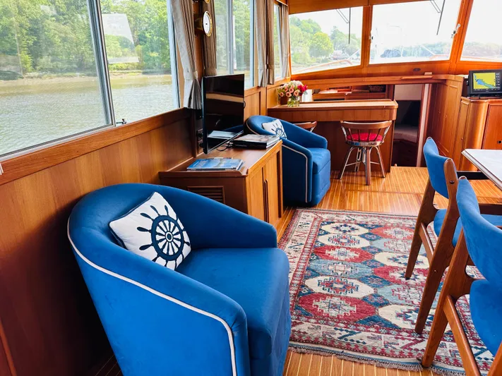 Sora Yacht Photos Pics Interior of 1998 Grand Banks 49 Classic yacht with blue chairs and nautical decor.