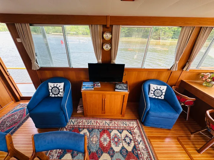 Sora Yacht Photos Pics Interior of 1998 Grand Banks 49 Classic yacht with blue chairs and scenic window view.