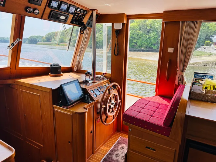 Sora Yacht Photos Pics Interior of 1998 Grand Banks 49 Classic yacht with wooden helm and scenic view.