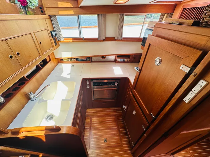 Sora Yacht Photos Pics Interior of 1998 Grand Banks 49 Classic yacht, featuring a wooden kitchen with sink and appliances.