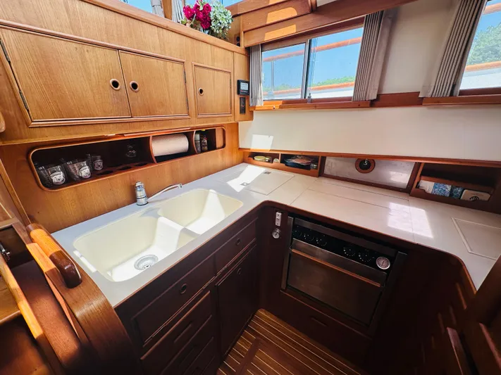 Sora Yacht Photos Pics 1998 Grand Banks 49 Classic yacht kitchen with wooden cabinetry and modern appliances.