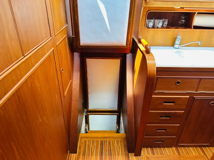 Sora Yacht Photos Pics Interior of 1998 Grand Banks 49 Classic yacht with wooden cabinetry and sink.