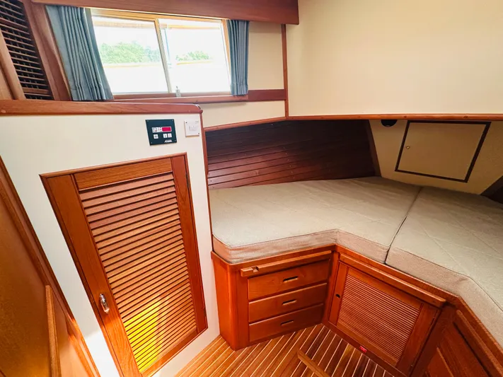 Sora Yacht Photos Pics 1998 Grand Banks 49 Classic cabin interior with wooden finish and cozy bed.