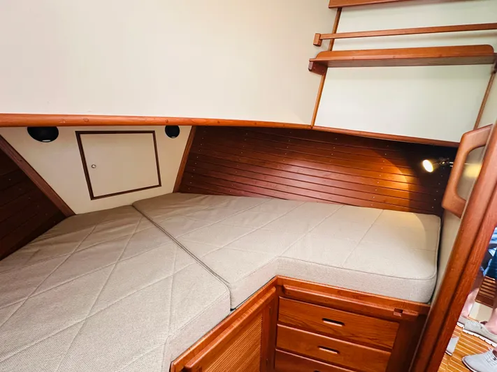 Sora Yacht Photos Pics 1998 Grand Banks 49 Classic cabin with wooden interior and cozy bed.