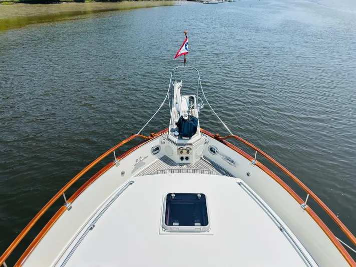 Sora Yacht Photos Pics Grand Banks 49 Classic yacht bow view on calm water, 1998 model.
