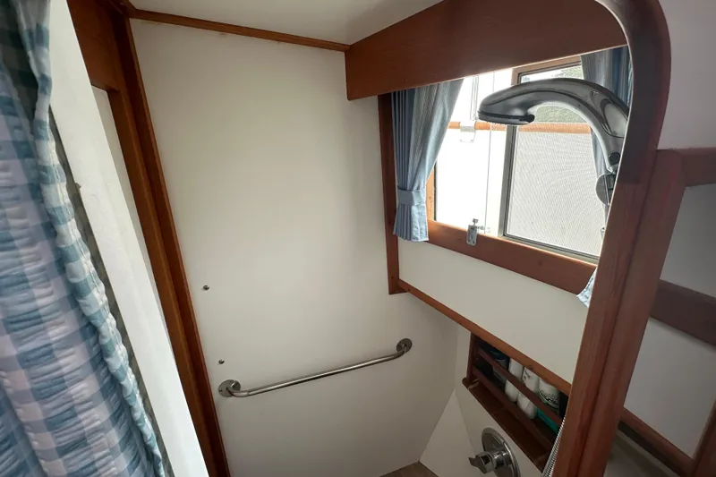 Sora Yacht Photos Pics Bathroom interior of 1998 Grand Banks 49 Classic yacht with shower and window.