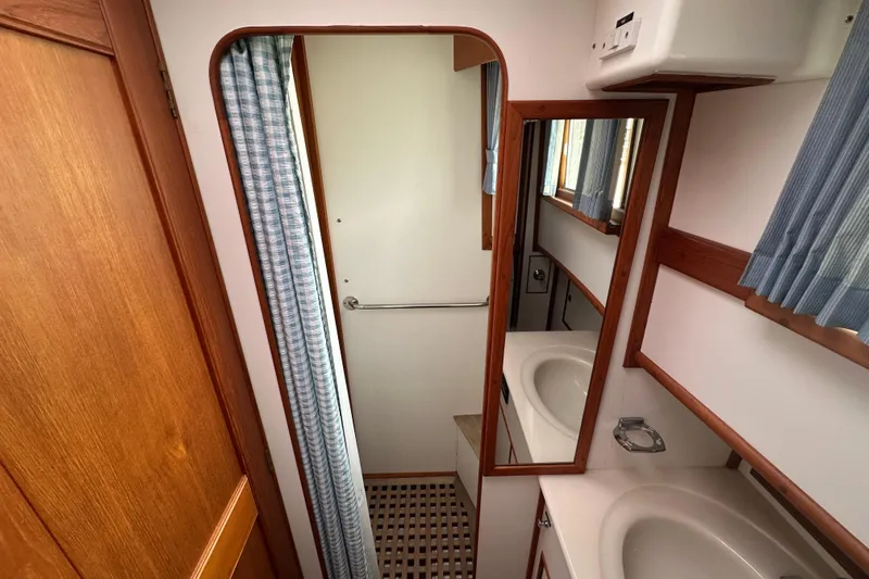 Sora Yacht Photos Pics Bathroom interior of 1998 Grand Banks 49 Classic yacht with sink and mirror.