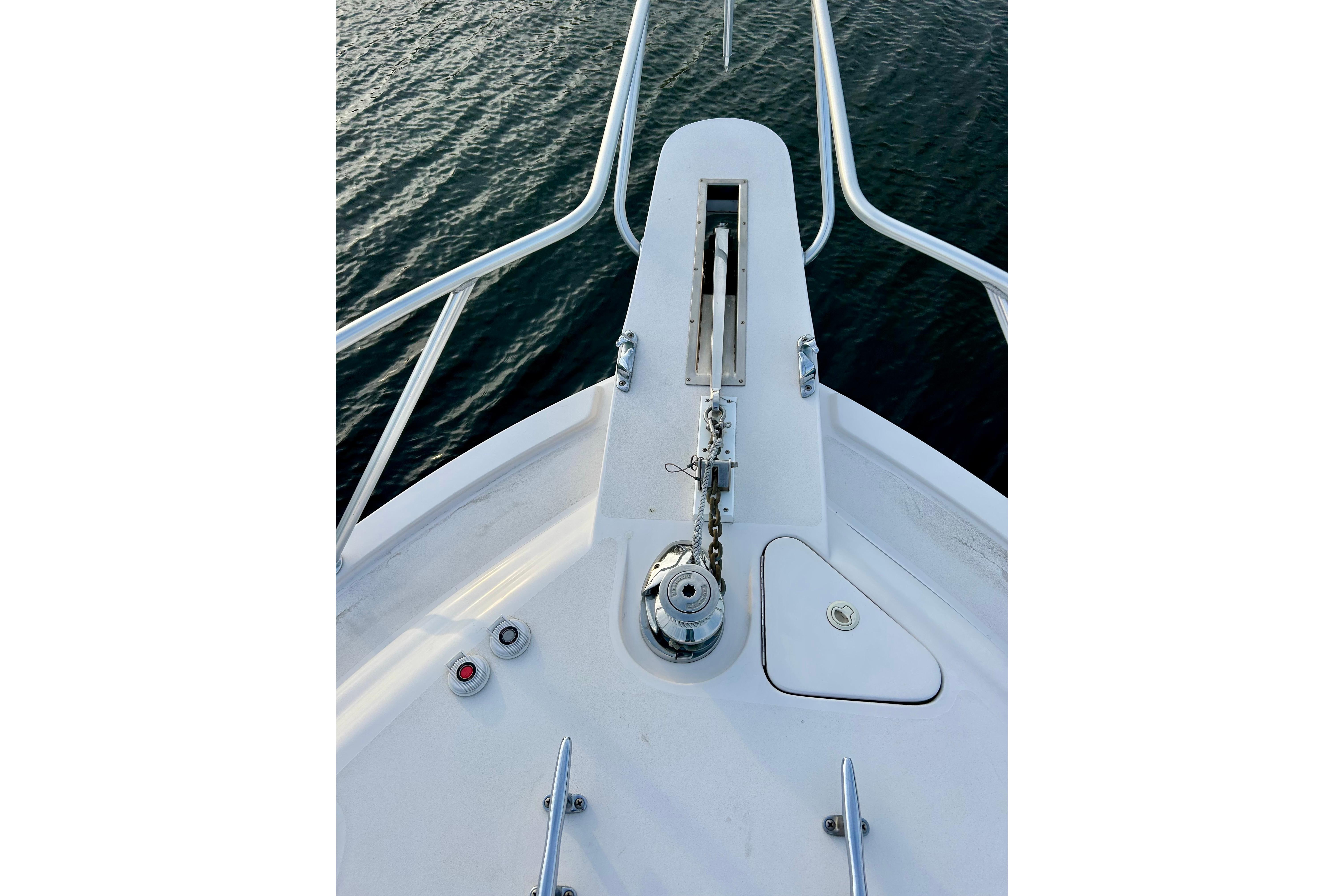 Bow of 2005 Bertram 390 Convertible yacht with anchor chain and railing.