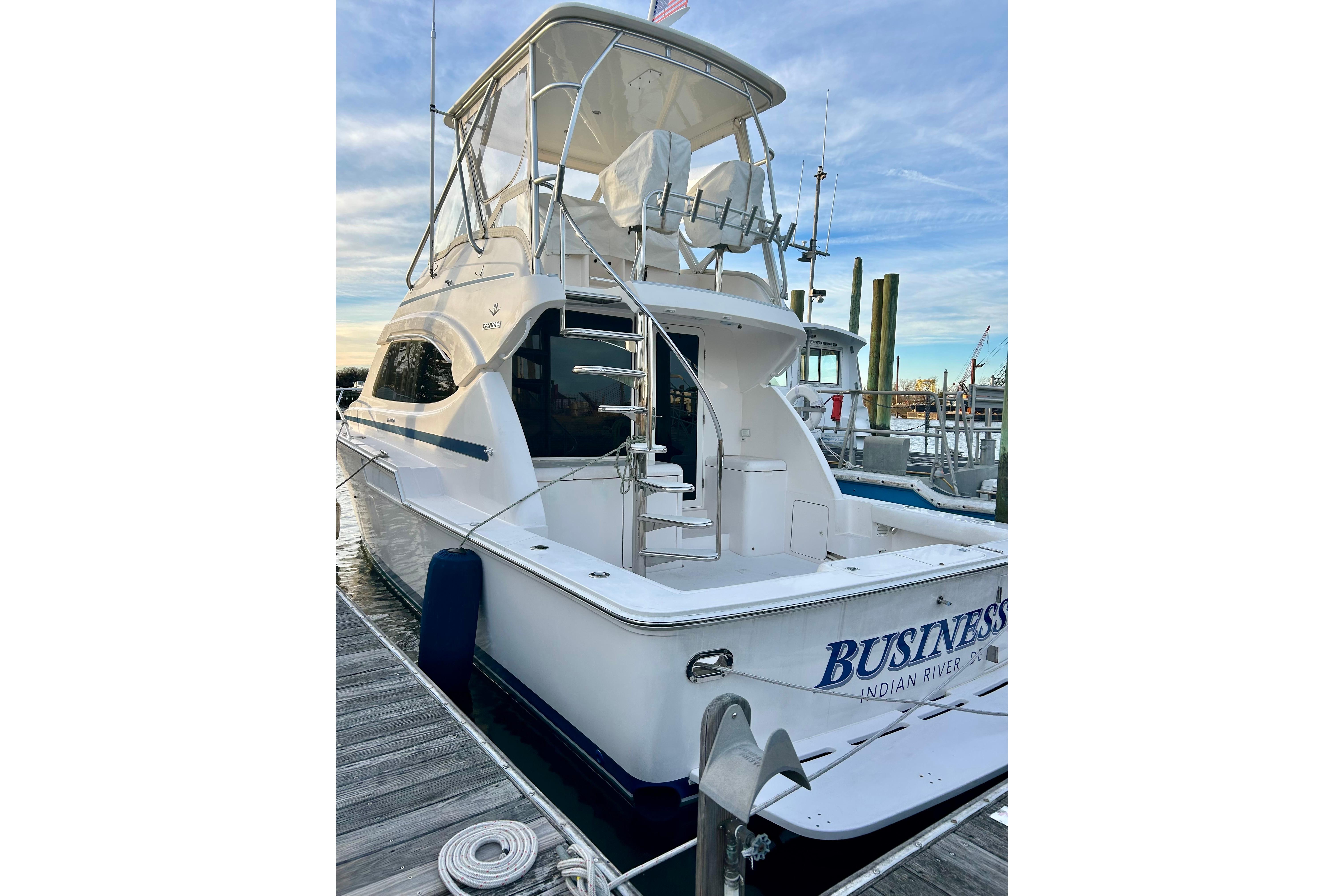 2005 Bertram 390 Convertible yacht docked at marina, rear view.