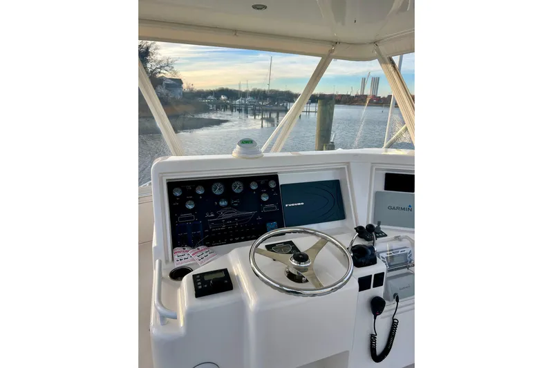  Yacht Photos Pics Helm of 2005 Bertram 390 Convertible with navigation equipment, overlooking marina.