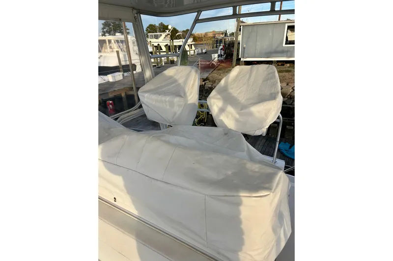  Yacht Photos Pics 2005 Bertram 390 Convertible boat interior with covered seating at dock.