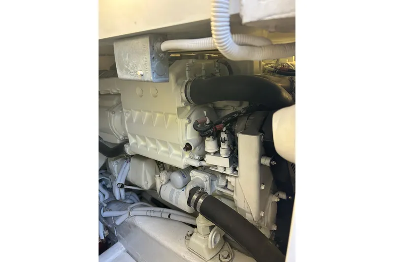  Yacht Photos Pics Engine compartment of a 2005 Bertram 390 Convertible boat, showcasing mechanical components.