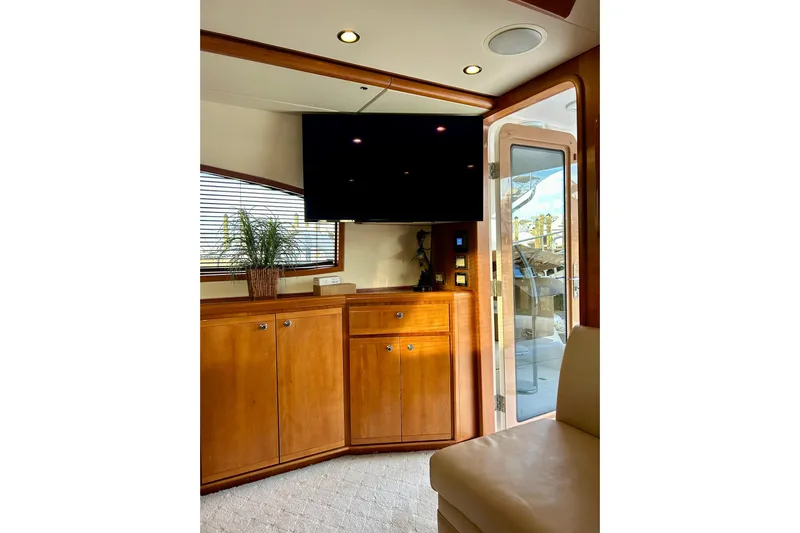  Yacht Photos Pics Interior of 2005 Bertram 390 Convertible yacht with wooden cabinetry and mounted TV.