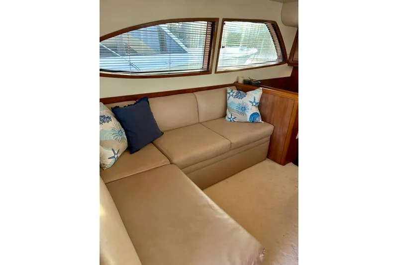  Yacht Photos Pics Interior of 2005 Bertram 390 Convertible with beige leather seating and decorative pillows.