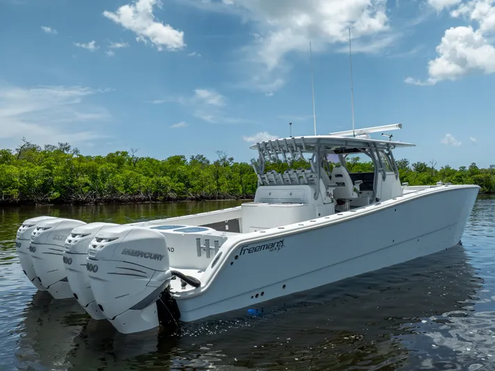  Yacht Photos Pics 2019 Freeman 42 LR boat with triple Mercury engines on calm water.