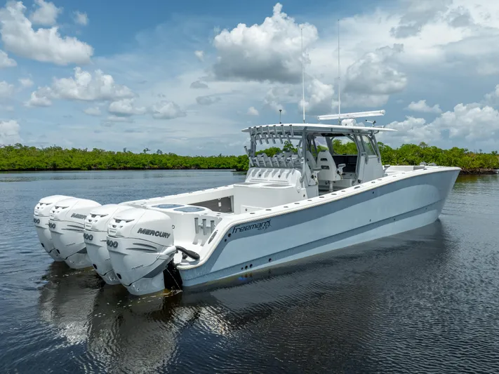  Yacht Photos Pics 2019 Freeman 42 LR boat with triple Mercury engines on calm water.