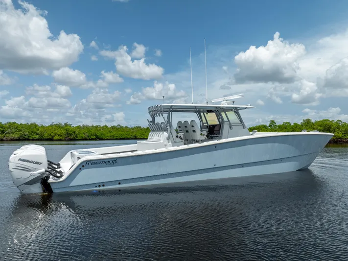  Yacht Photos Pics 2019 Freeman 42 LR boat on calm water with blue sky and clouds.