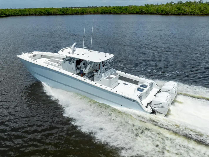  Yacht Photos Pics 2019 Freeman 42 LR boat cruising on a river with twin outboard engines.
