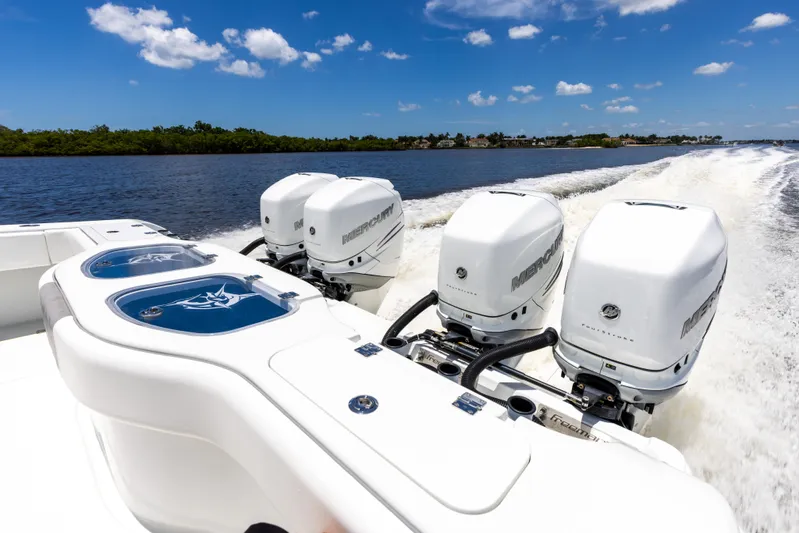  Yacht Photos Pics 2019 Freeman 42 LR boat with powerful outboard engines cruising on a sunny day.