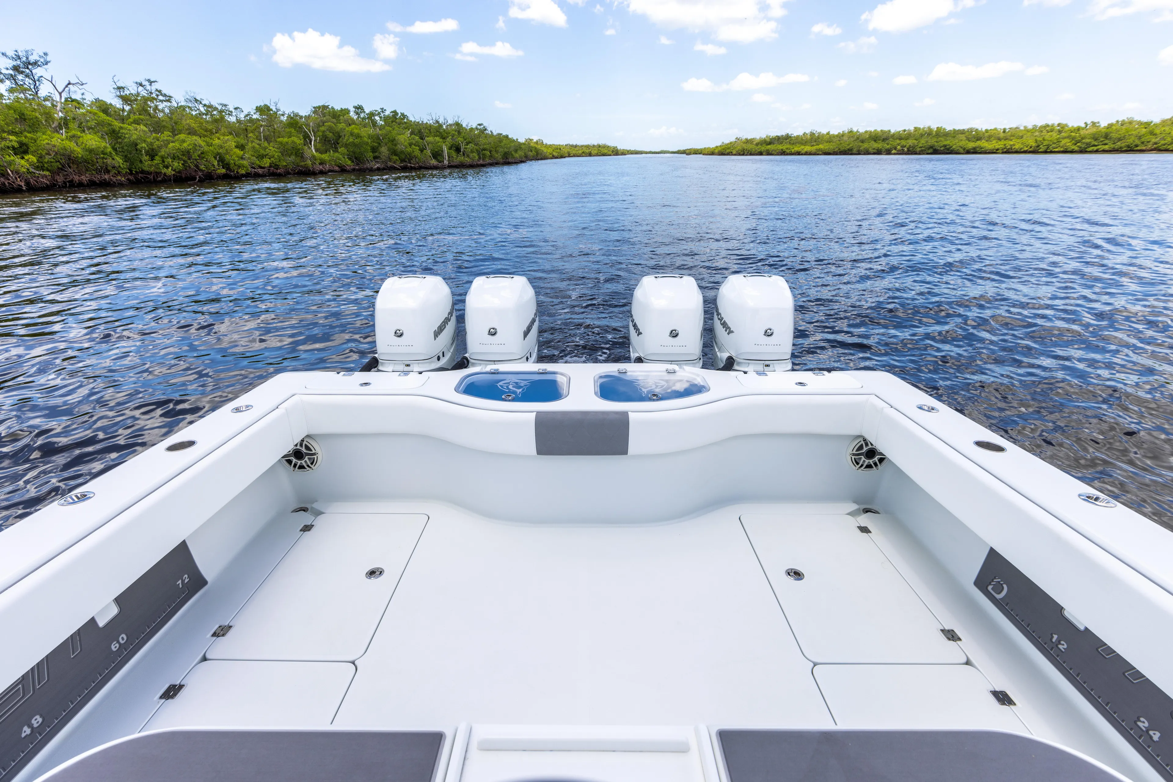 Yacht Photos Pics 2019 Freeman 42 LR boat with quad outboard engines on a serene waterway.
