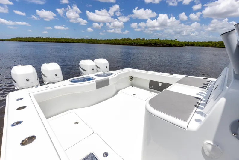  Yacht Photos Pics 2019 Freeman 42 LR boat with four outboard motors on a calm lake.