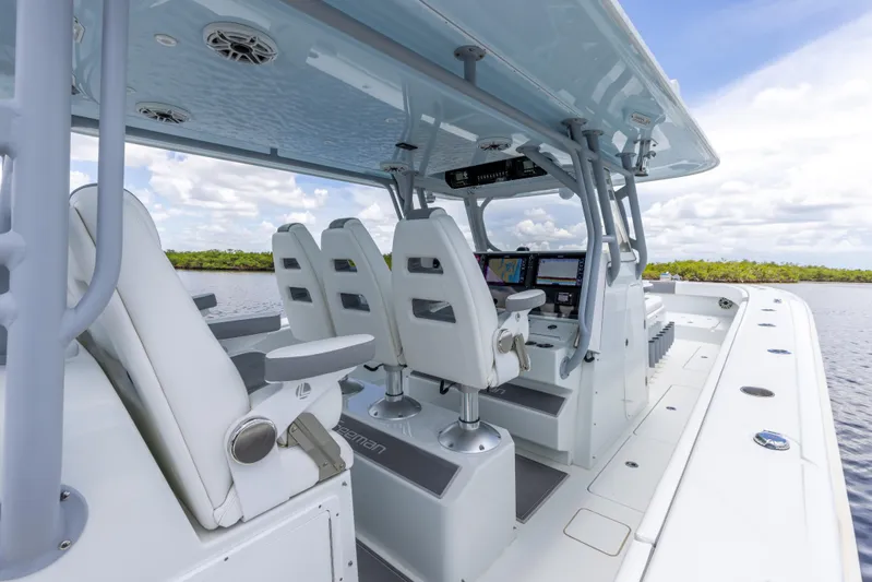  Yacht Photos Pics 2019 Freeman 42 LR boat interior with white seating and advanced navigation system.