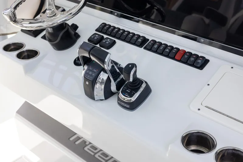  Yacht Photos Pics Control panel of a 2019 Freeman 42 LR boat with steering wheel and throttle.