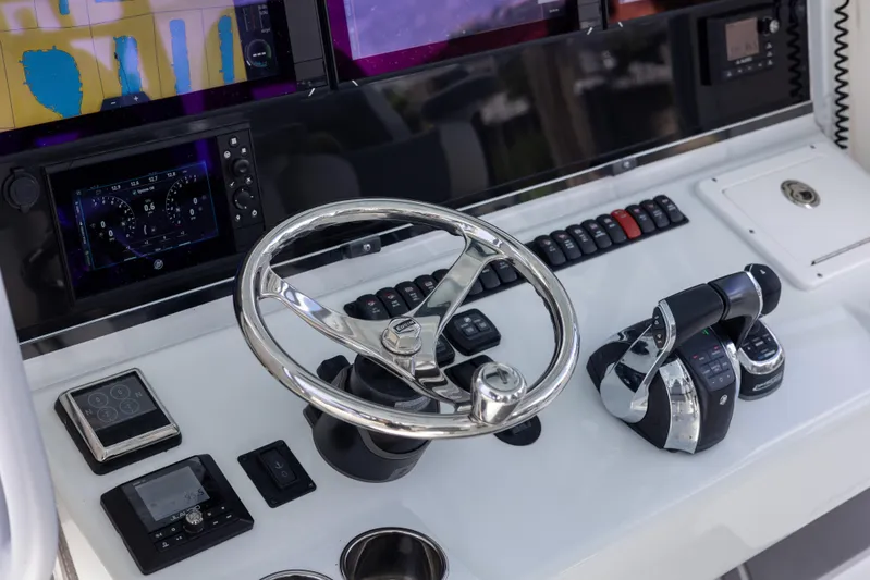  Yacht Photos Pics Control panel of a 2019 Freeman 42 LR boat with steering wheel and throttle.