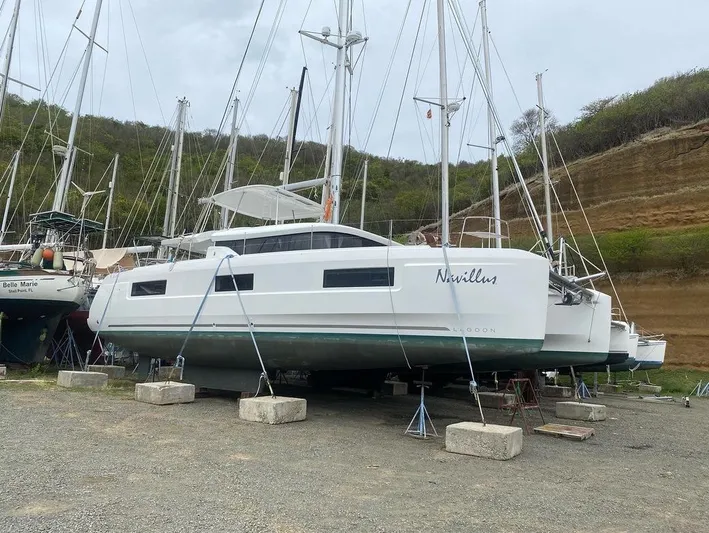 Navillus-3 Yacht Photos Pics 2022 Lagoon 46 catamaran on land, supported by blocks and stands.