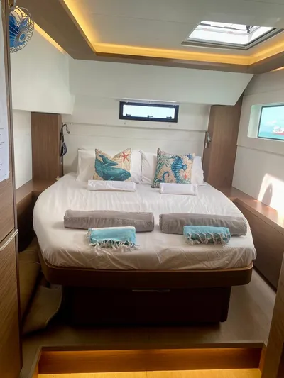 Navillus-3 Yacht Photos Pics Luxurious bedroom interior of 2022 Lagoon 46 yacht with modern decor and natural lighting.
