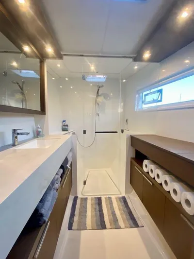 Navillus-3 Yacht Photos Pics Modern bathroom in 2022 Lagoon 46 yacht with shower, vanity, and storage.