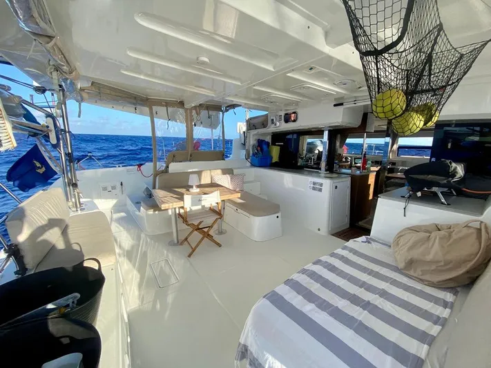 Navillus-3 Yacht Photos Pics 2022 Lagoon 46 yacht interior with seating, dining area, and ocean view.