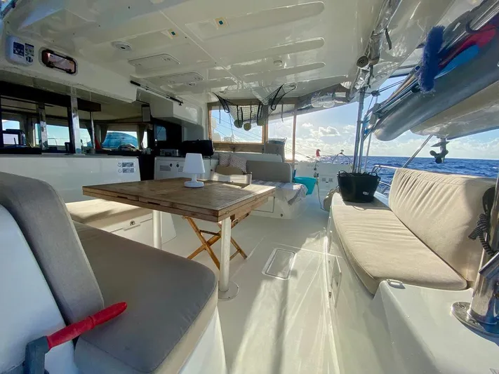 Navillus-3 Yacht Photos Pics Luxurious 2022 Lagoon 46 catamaran interior with seating, table, and ocean view.