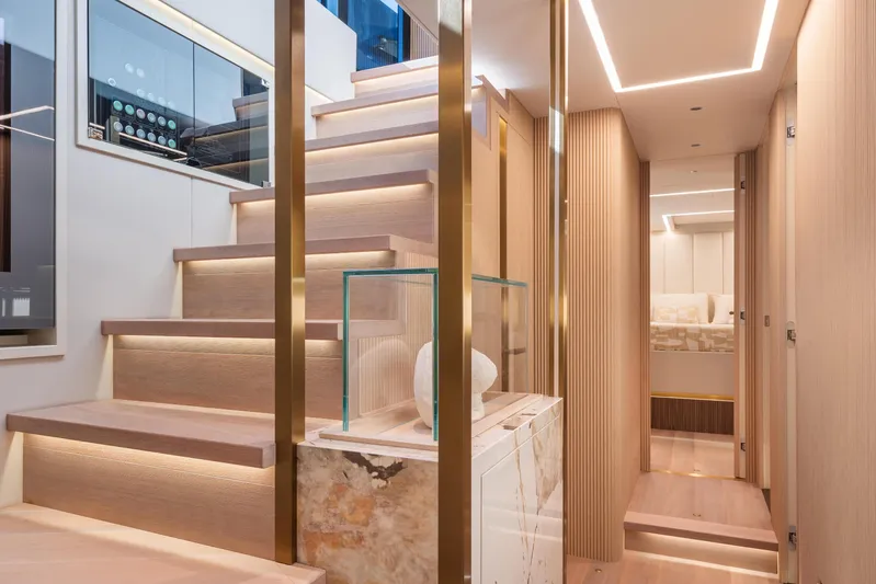  Yacht Photos Pics Luxurious interior of 2025 Explorer 62 yacht with modern staircase and elegant lighting.