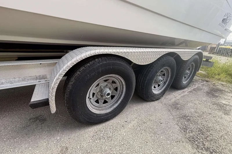  Yacht Photos Pics Triple-axle trailer for 2013 Andros Offshore 32 boat, featuring diamond plate fenders.