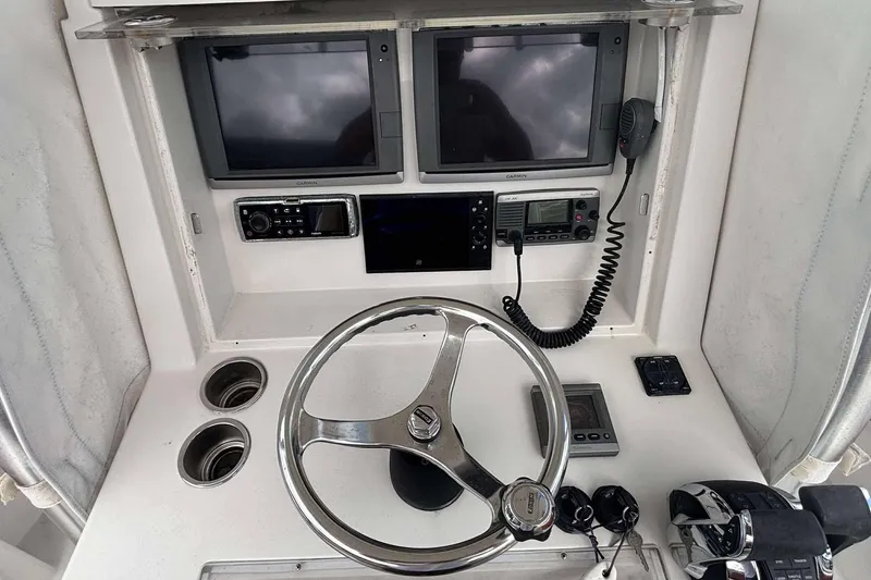  Yacht Photos Pics Steering console of 2013 Andros Offshore 32 boat with navigation equipment and controls.
