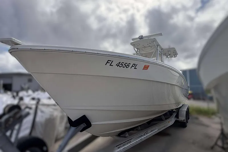  Yacht Photos Pics 2013 Andros Offshore 32 boat on trailer, registration FL 4556 PL, cloudy sky background.
