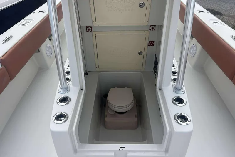  Yacht Photos Pics 2013 Andros Offshore 32 boat interior with built-in toilet and storage compartments.