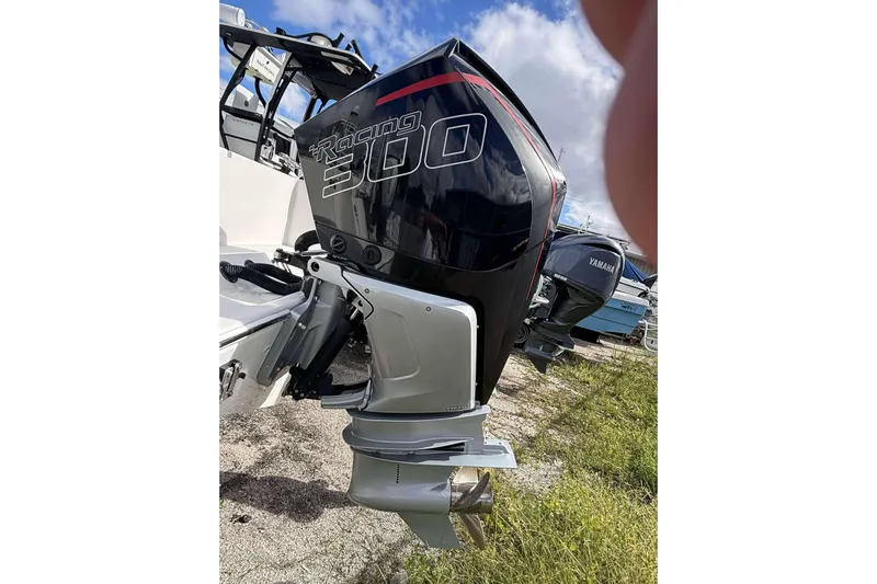  Yacht Photos Pics 2013 Andros Offshore 32 with Racing 300 outboard motor, parked on grass.