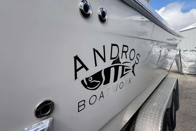  Yacht Photos Pics 2013 Andros Offshore 32 boat with logo, parked on a trailer.