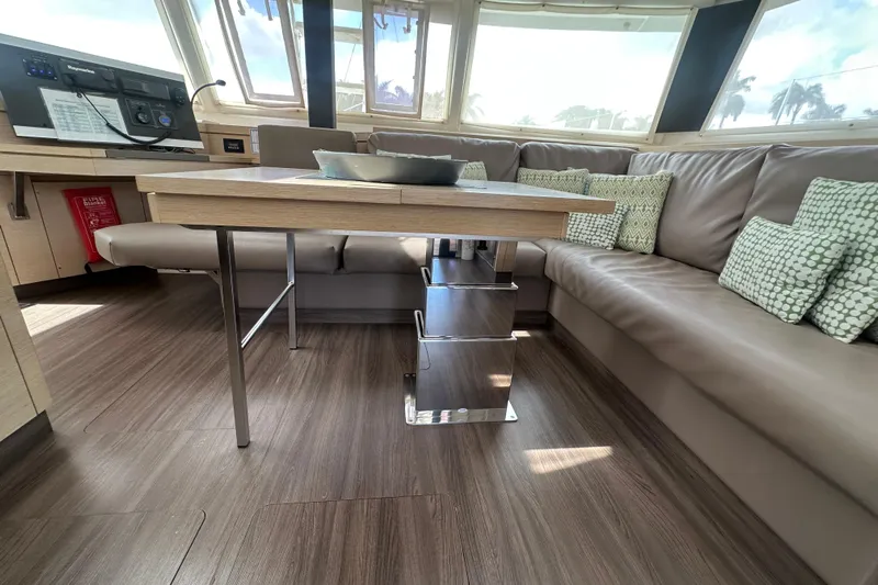 Grand Crew Yacht Photos Pics Luxurious interior of 2019 Fountaine Pajot 47 catamaran with modern seating and table.