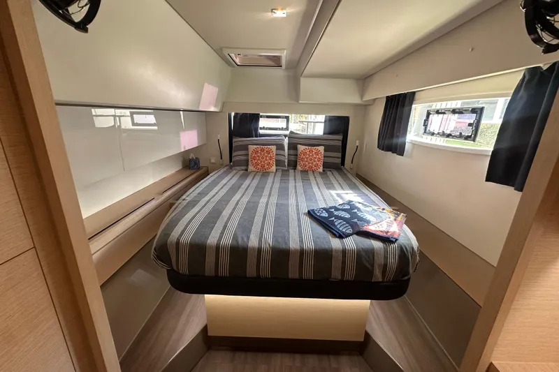 Grand Crew Yacht Photos Pics Luxurious cabin interior of 2019 Fountaine Pajot 47 yacht with striped bedding.