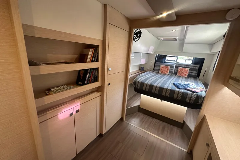 Grand Crew Yacht Photos Pics Luxurious 2019 Fountaine Pajot 47 yacht interior with cozy bedroom and modern wooden shelving.