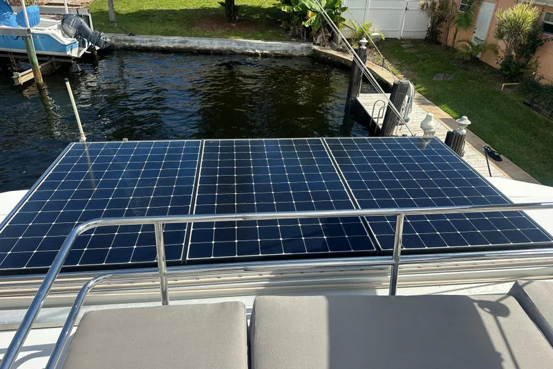 Grand Crew Yacht Photos Pics Solar panels on a 2019 Fountaine Pajot 47 catamaran docked by the water.